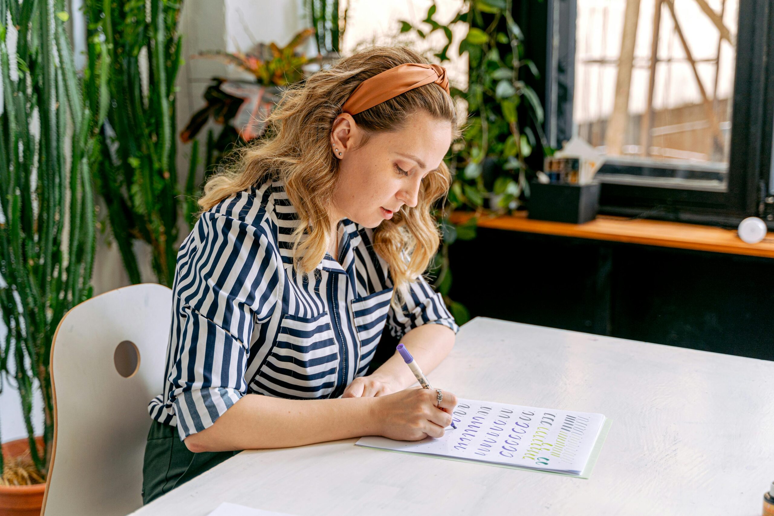 A Woman Practicing Hand Lettering at an Art School