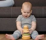 A Baby Playing with a Stacking Toy