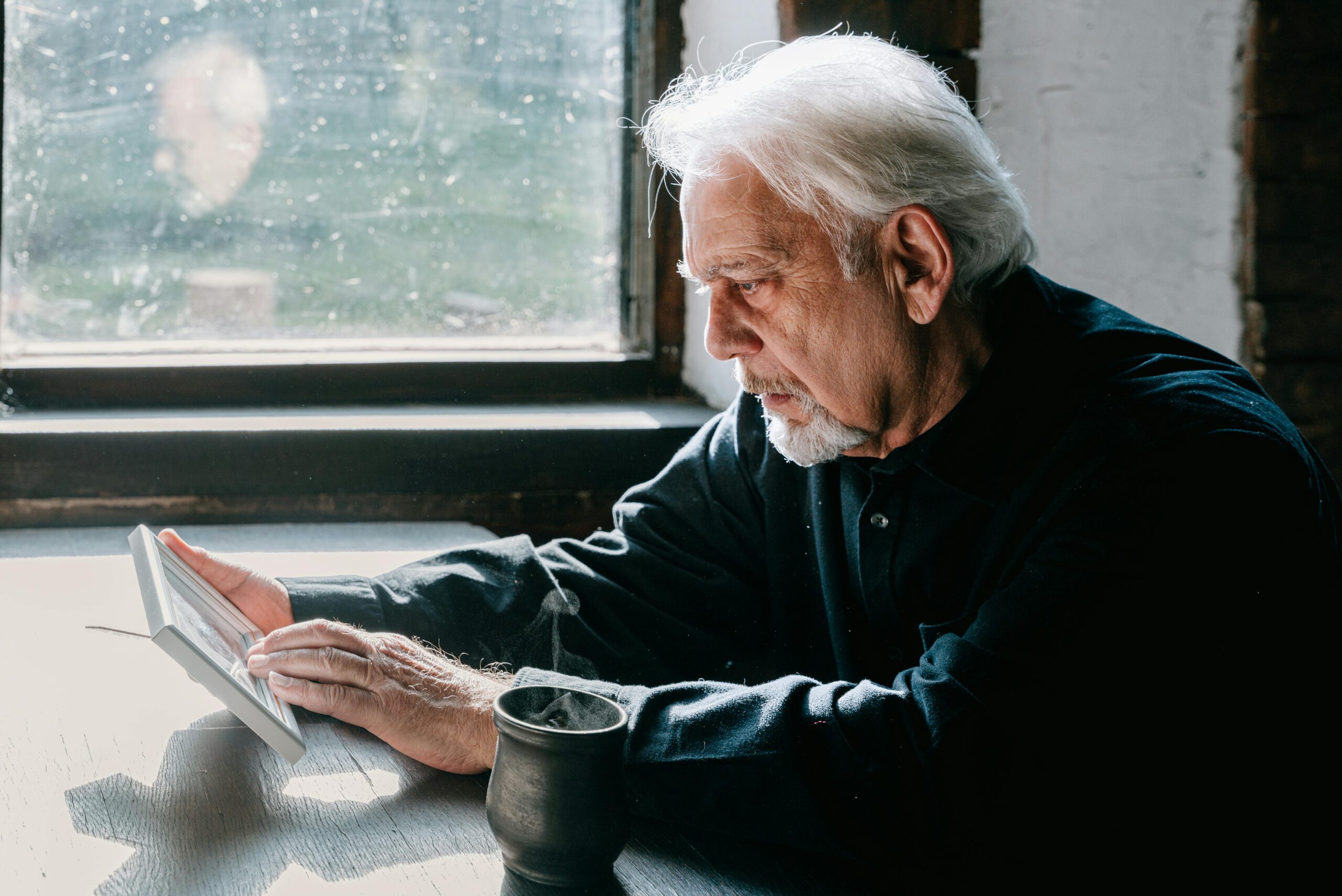 An Elderly Man Looking at a Picture